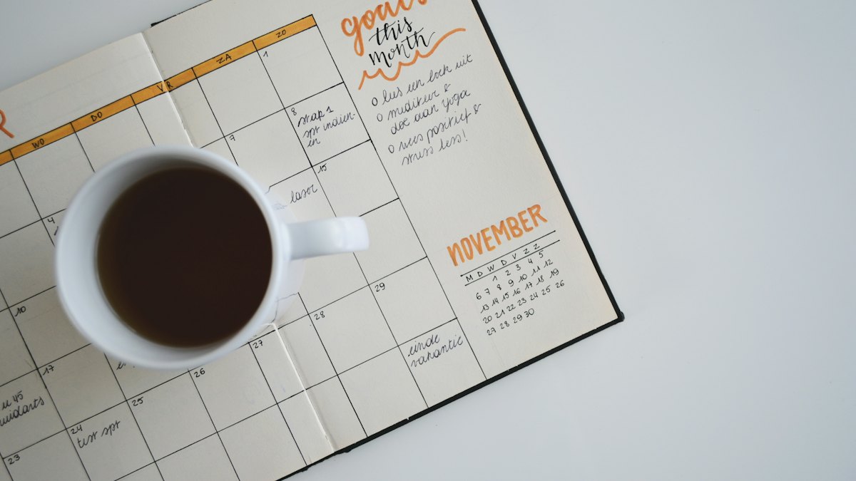 Desk planner and coffee cup, open to November